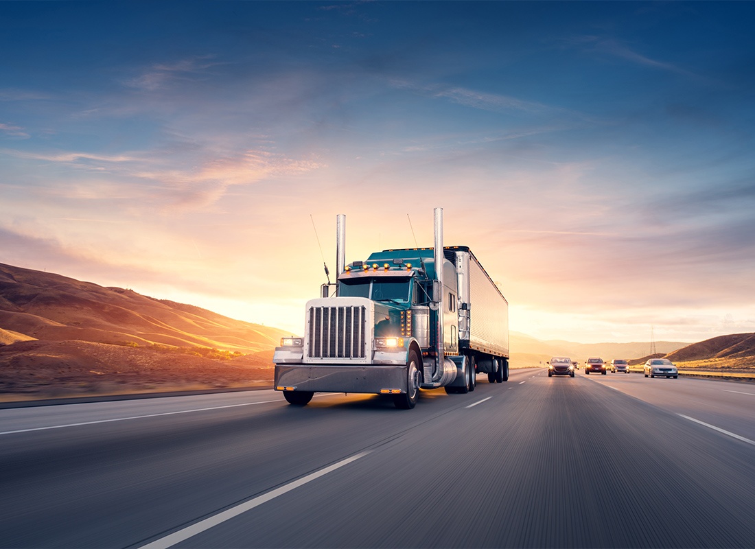 Business Insurance - Blue Truck Driving Down the Highway at a Fast Speed